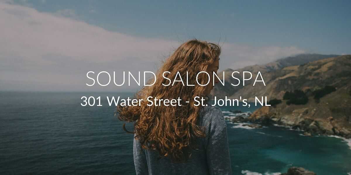 Woman with long hair stands overlooking a scenic ocean view. Text: Sound Salon Spa, St. John's, NL.