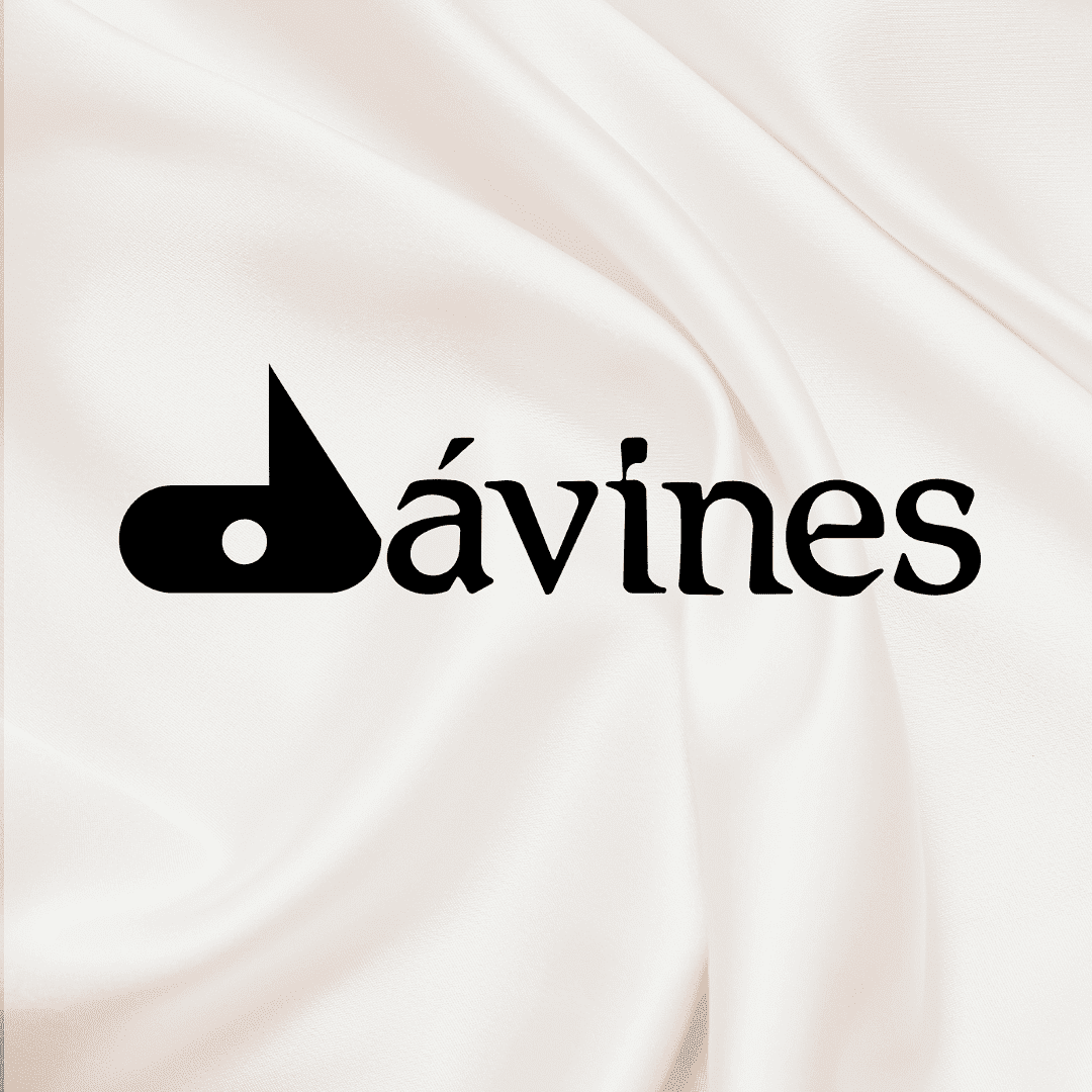 Davines logo on a soft, white fabric background.